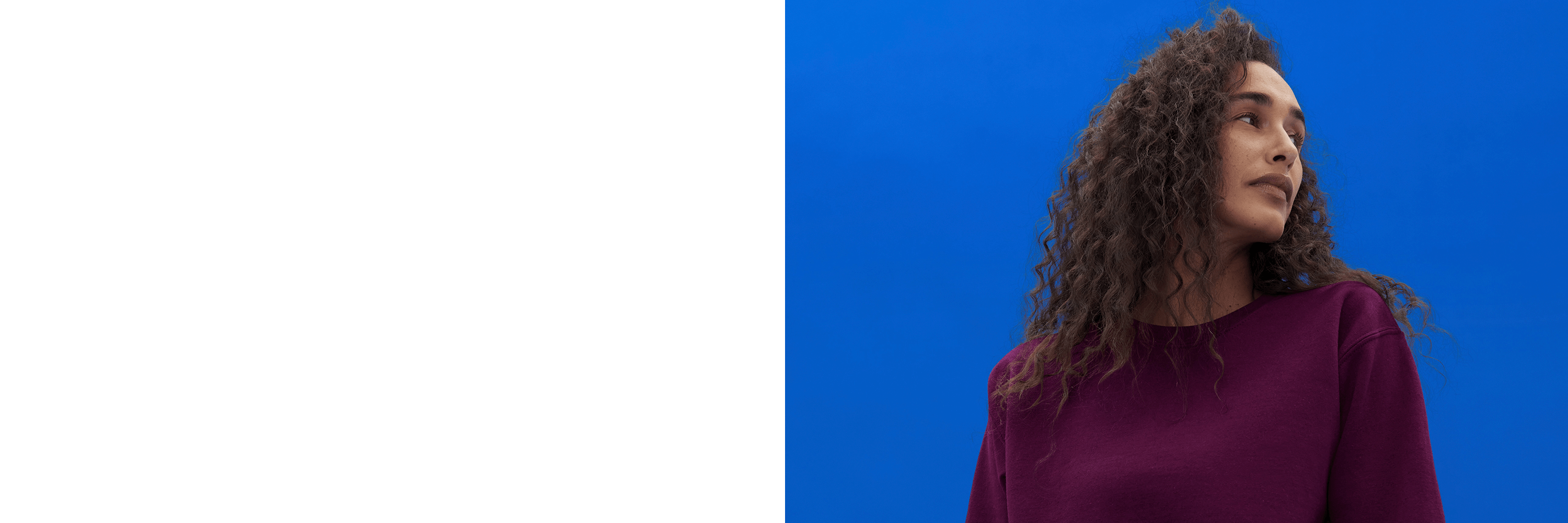 Woman wearing a purple sweater against a blue background